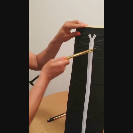 Hands demonstrating the ZipMyself 2-in-1 Dressing Tool zipping up a zipper