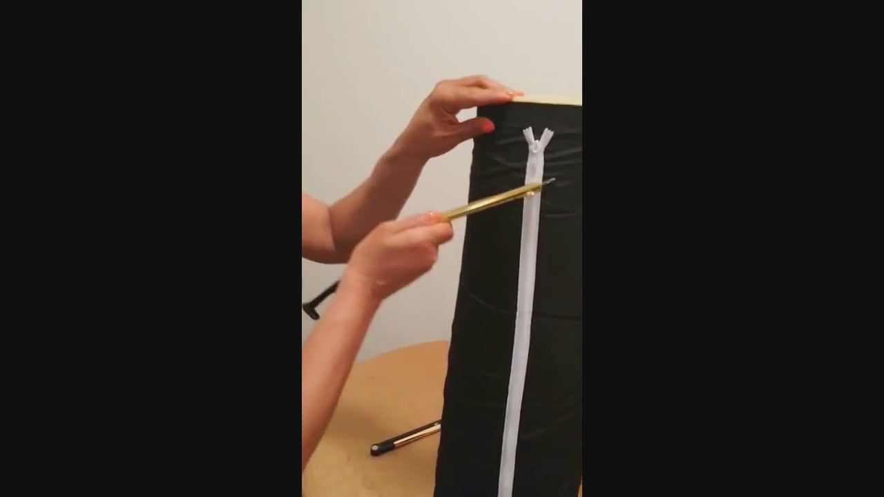 Hands demonstrating the ZipMyself 2-in-1 Dressing Tool zipping up a zipper
